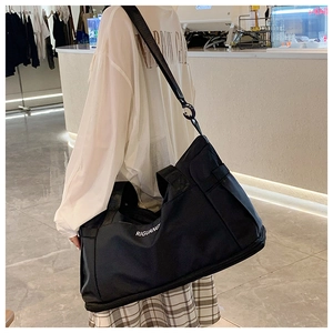 Detail of black waterproof travel bag featuring RIGUANG lettering and crossbody strap
