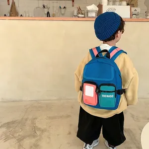 Cute color-block children backpack in navy blue canvas with pink and green pockets