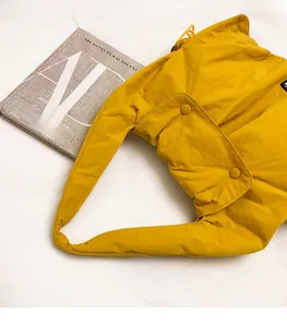 Top view of bright yellow large nylon tote bag with drawstring and snap button detail
