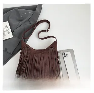 Detailed view of the brown suede fringe tote bag with adjustable shoulder strap and boho tassels