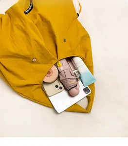 Detailed interior of yellow drawstring tote bag showing high capacity for daily essentials
