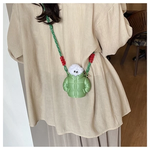 Detailed shot of green down jacket style mini crossbody bag with cute moving eyes