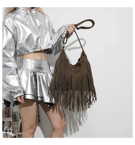 Detailed view of dark brown suede fringe bag with long tassels and matching strap