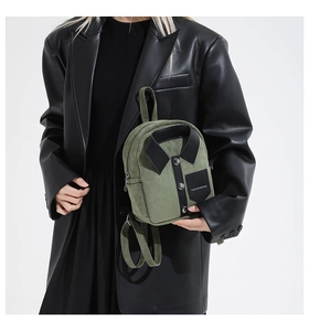 Detail of creative shirt-style backpack in dark green with black collar and buttons