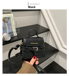 Detail view of the black retro mini handbag with fashion lettering and belt buckle