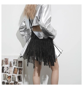 Close-up of black fringe tote bag with long tassels and sleek suede finish on the shoulder