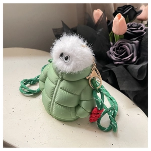 Close-up of green puffer jacket mini bag with fluffy top and golden metal buckle