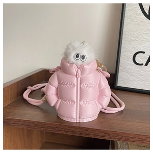 Detail of pink puffer-jacket styled mini bag with white plush trim and metal zipper