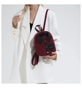 Close-up of a burgundy suede mini backpack featuring creative shirt collar and button details