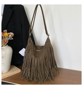 Close-up of deep brown fringed tote bag with premium suede texture and long tassels