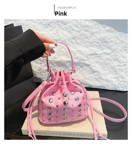 Close-up of pink bucket bag with silver studs and drawstring in a punk aesthetic style