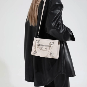 Off-white studded leather motorcycle handbag for women styled with a black jacket