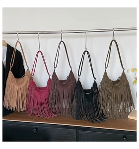 Detailed display of vintage fringe crossbody bags in five colors on a display stand