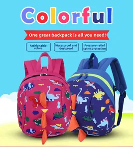 Close-up of waterproof dinosaur kids backpacks in pink and blue with 3D fins detail
