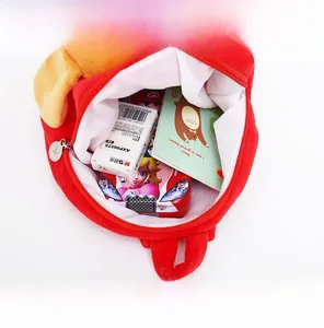 Interior view showing large capacity of red plush children backpack with stationery and books