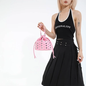 Chic pink bucket bag with silver studs and drawstring closure for stylish commuting