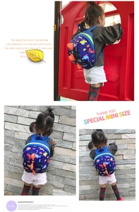 Detailed back view of mini dinosaur backpack featuring orange 3D spikes and colorful prints
