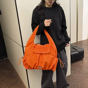 Large orange nylon tote bag with drawstring detail for women's casual daily commute