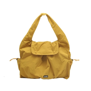 Large capacity yellow drawstring tote bag with flap closure and minimalist shoulder strap