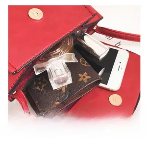 Internal view of red crossbody bag showing storage space for phone and accessories