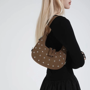 Brown suede hobo shoulder bag with silver rivet studs for women shown on a model