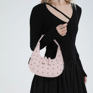 Pink punk-style hobo bag with silver studs and a crescent shape for women's fashion