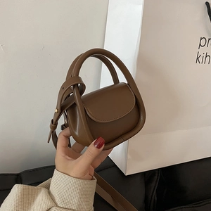 Chic dark brown mini leather handbag for kids featuring gold hardware and shoulder strap
