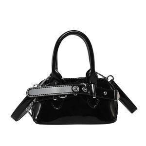 Minimalist black patent leather shell handbag with silver hardware and shoulder strap