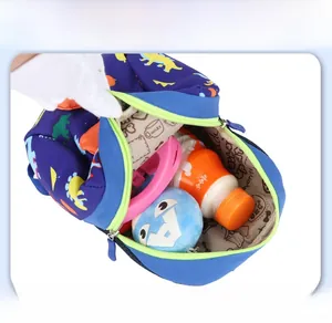 Top view showing the spacious interior of a navy dinosaur print kids backpack with items