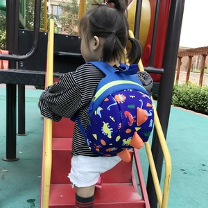 Toddler backpack with colorful dinosaur prints and orange 3D spikes for outdoor activities