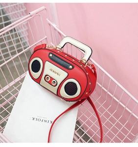 Dettaglio borsa radio retrò con borchie dorate e logo JINGPIN in un cesto rosa