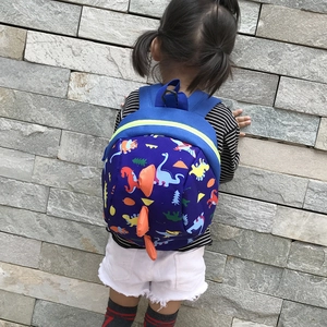 Kids navy blue dinosaur backpack with 3D orange fins and colorful pattern on toddler