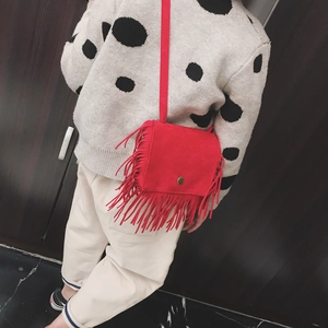 Fashionable red tassel shoulder bag for kids featuring soft faux suede and metal snap button