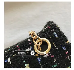 Detail of colorful tweed fabric with high-quality gold eyelets and metal chain strap