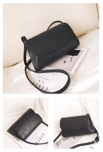 Macro view of minimalist black leather crossbody bag featuring gold hardware and fine stitching