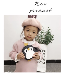 Detail view of the cute penguin round crossbody bag showing fine stitching and leather texture