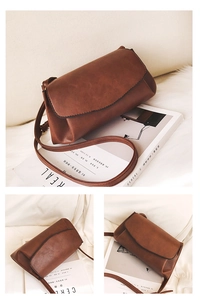 Detailed views of brown vintage matte leather crossbody bag on soft white faux fur background