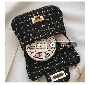 Detail showing internal capacity of the black tweed chain bag with lipstick and cushion