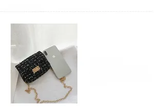 Detail view of colorful tweed mini bag with golden metal lock and chain strap for girls