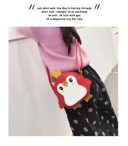 Detail showing the red cartoon penguin kid crossbody bag with colorful side wings