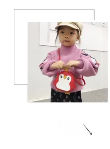 Cute red penguin crossbody bag for girls with adjustable strap shown on a child model