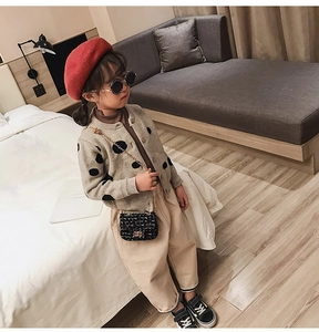 Kid fashion set featuring a black tweed chain bag with a red beret and knitted cardigan