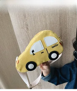 Detail view of yellow corduroy car-shaped kids waist bag with cartoon embroidery