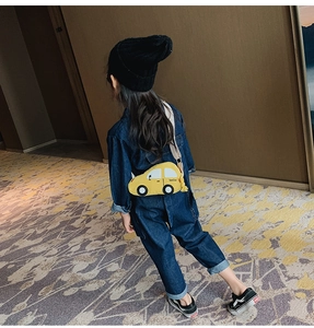 Detail of adjustable strap and cartoon car shape on this yellow children's crossbody bag