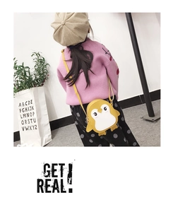 Detailed back view of a child wearing a yellow penguin crossbody bag with a slim strap