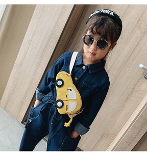 Kids yellow car-shaped corduroy chest bag shown on model with blue denim outfit