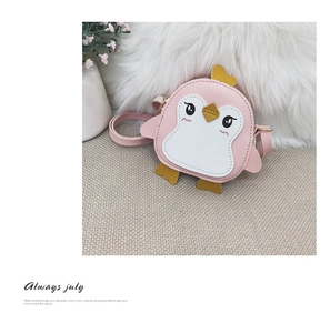 Pink penguin cartoon crossbody bag with metal zipper on soft textured background