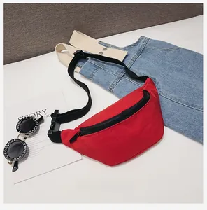 Detail of red canvas kids waist bag with black zipper and adjustable strap on a white background