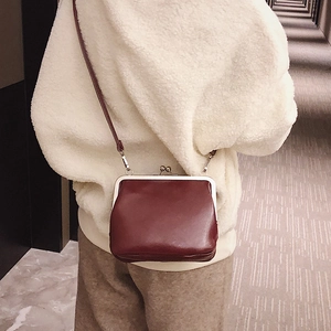 Retro dark red crossbody bag with metal kiss-lock closure and slim leather shoulder strap