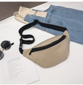 Close-up of beige canvas waist bag with adjustable black strap and durable zipper